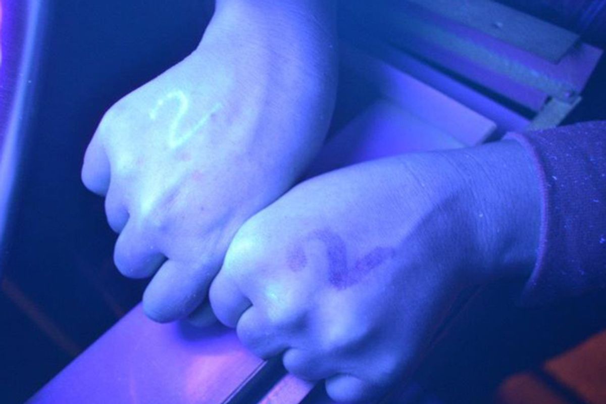 An Occupy Montreal protester's hand is shown under UV light after being marked by police.    (Nina Haigh/Facebook)