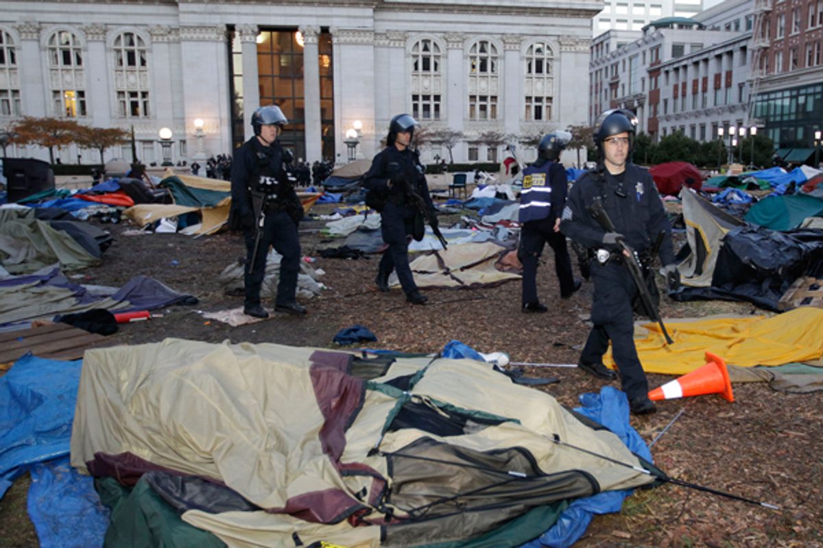 Police in Oakland began clearing out a weeks-old encampment early Monday, after issuing several warnings to Occupy demonstrators.   (AP/Paul Sakuma)