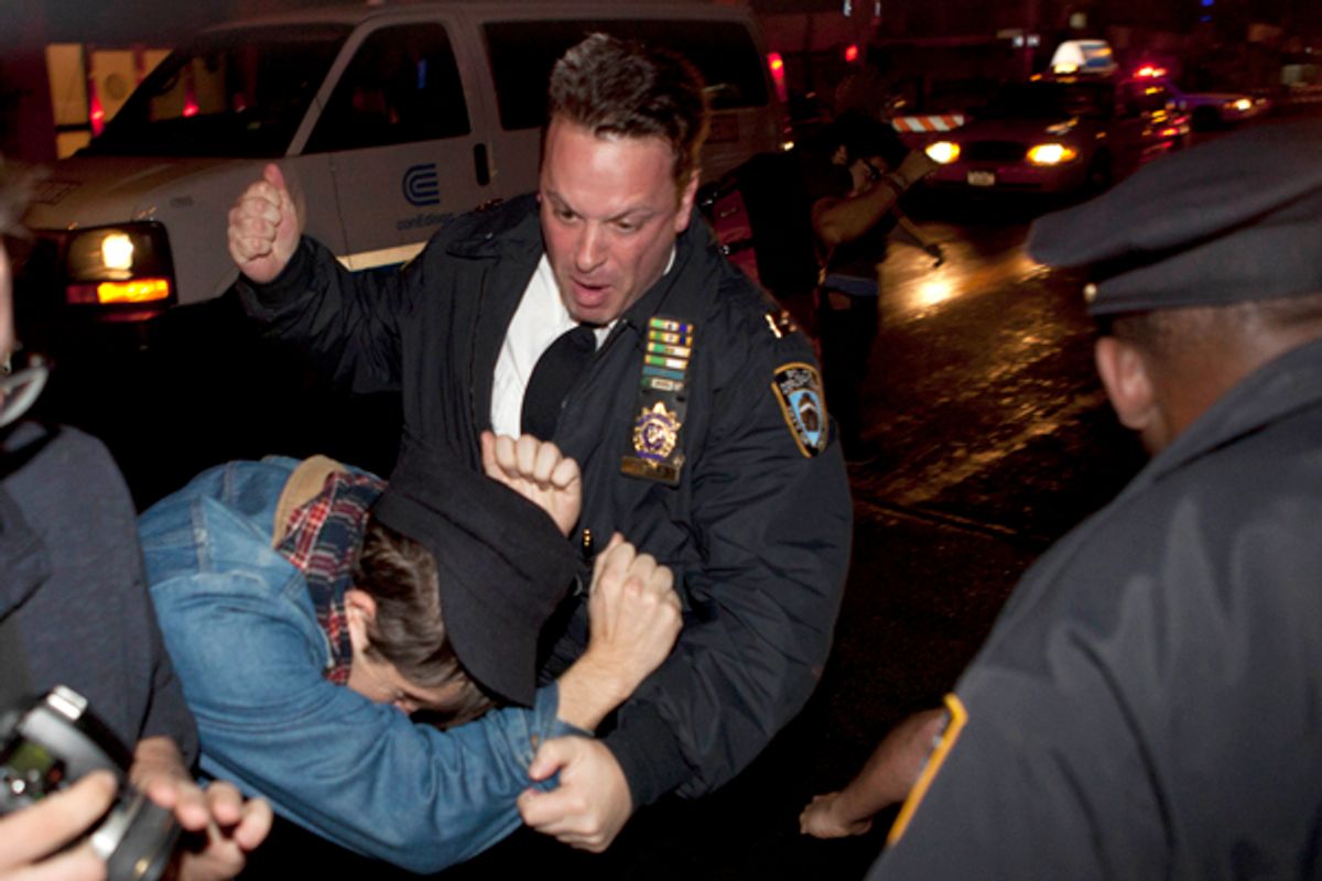 An Occupy Wall Street protester draws contact from a police officer near Zuccotti Park after being ordered to leave the longtime encampment in New York, Nov. 15, 2011             (AP/John Minchillo)