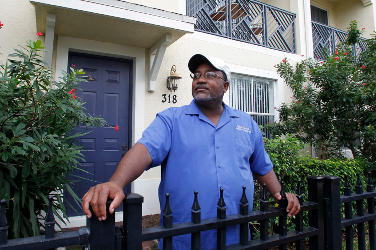 Curtis Jones stands in front of his two-story townhouse in Delray Beach, Fla., in October 2010. Seven years ago, Jones took out a mortgage with Countrywide Financial Corp to buy his home. The company has now launched foreclosure proceedings against him. Jones has fought for more than a year to keep his home from being foreclosed.      (Joe Skipper / Reuters)