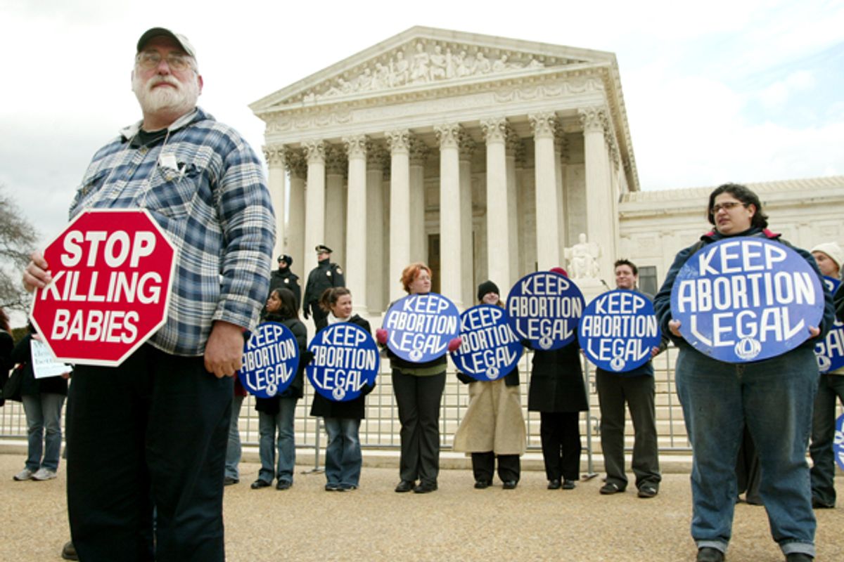 Pro-life and Pro-Choice demonstrators stand in front of the Supreme Court during a pro-life rally in Washington      (Reuters)