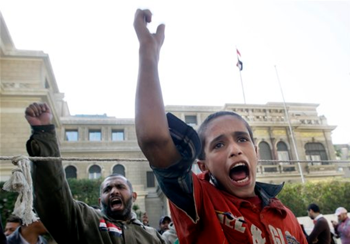  An Egyptian boy shouts slogans during a protest demanding the ruling military council to step down in front of the cabinet office in Cairo, Egypt, Sunday, Dec. 4, 2011.  (AP Photo/Amr Nabil)
