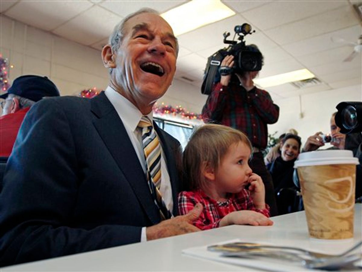 Republican presidential candidate Rep. Ron Paul, R-Texas, laughs as he sits down with Elizabeth Rose Chamberlain, 3, of Epping, N.H., while campaigning at the Early Bird Cafe in Plaistow, N.H., Tuesday Dec. 20, 2011. (AP Photo/Charles Krupa)    (AP)