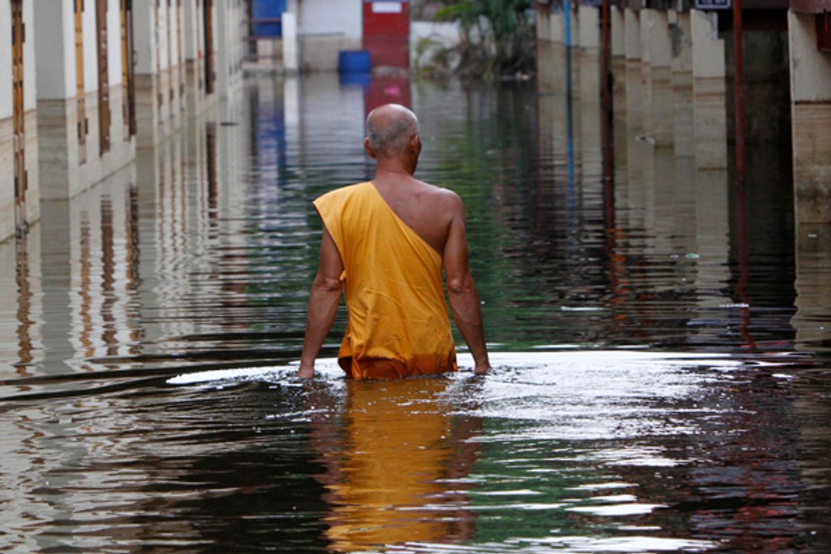 A Buddhist monk wades through a flooded temple in Bangkok.      (Reuters/Sukree Sukplang)