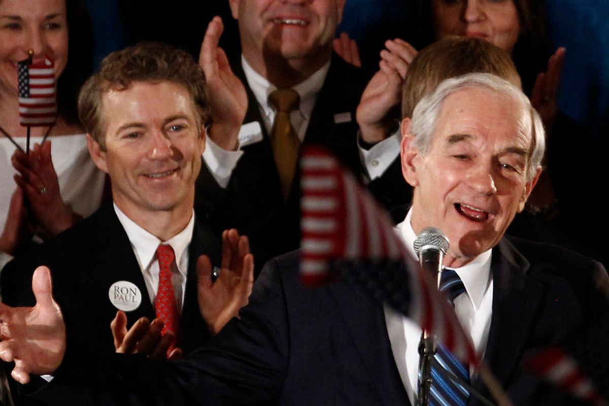 Republican presidential candidate Congressman Ron Paul speaks to supporters as his son Senator Rand Paul (L) applauds at his Iowa Caucus night rally in Ankeny, Iowa, January 3, 2012     (Jim Young / Reuters)