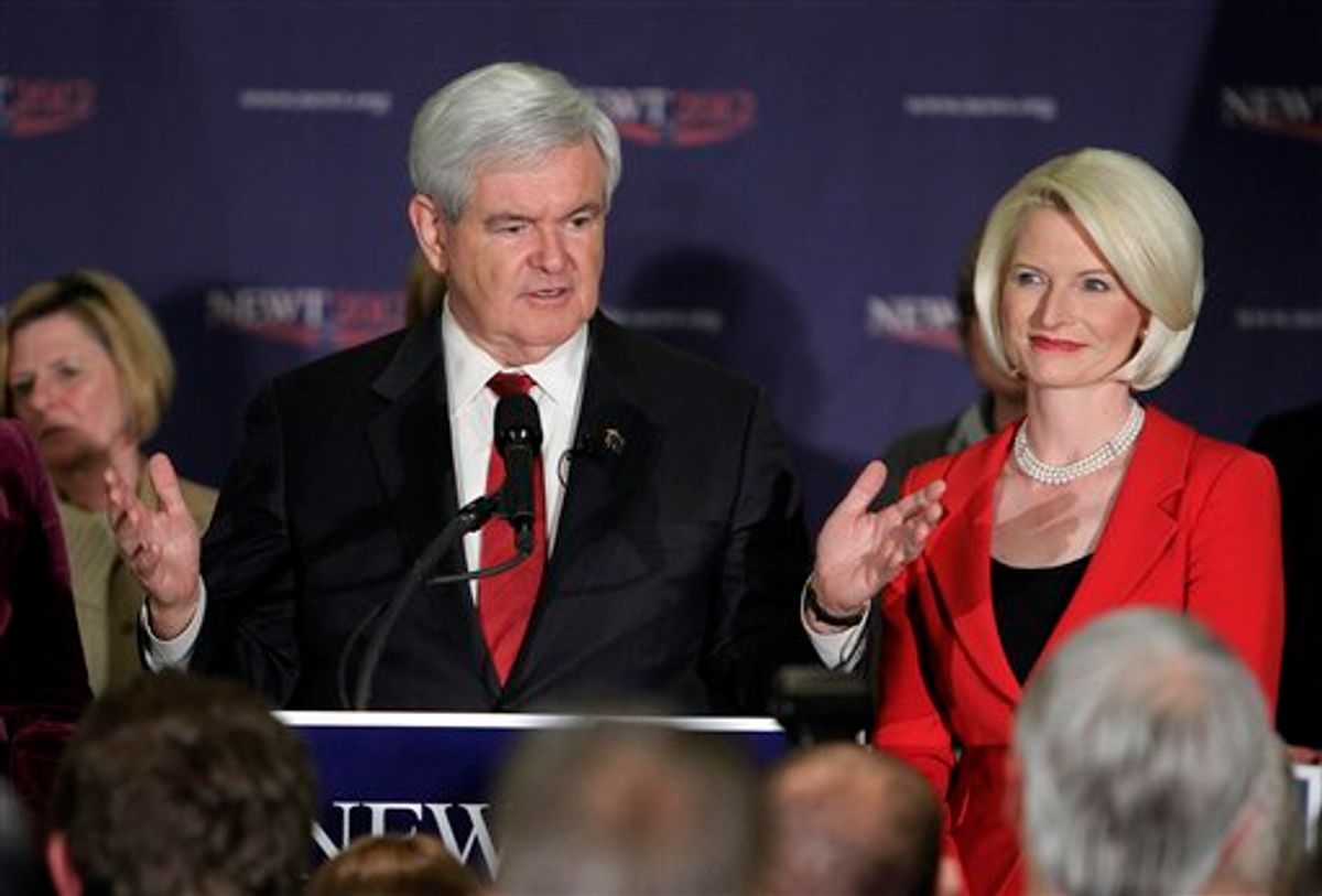 Republican presidential candidate, former House Speaker Newt Gingrich speaks to supporters at his rally headquarters Tuesday, Jan. 10, 2012, in Manchester, N.H., as his wife Callista watches. (AP Photo/Jim Cole)     (AP)