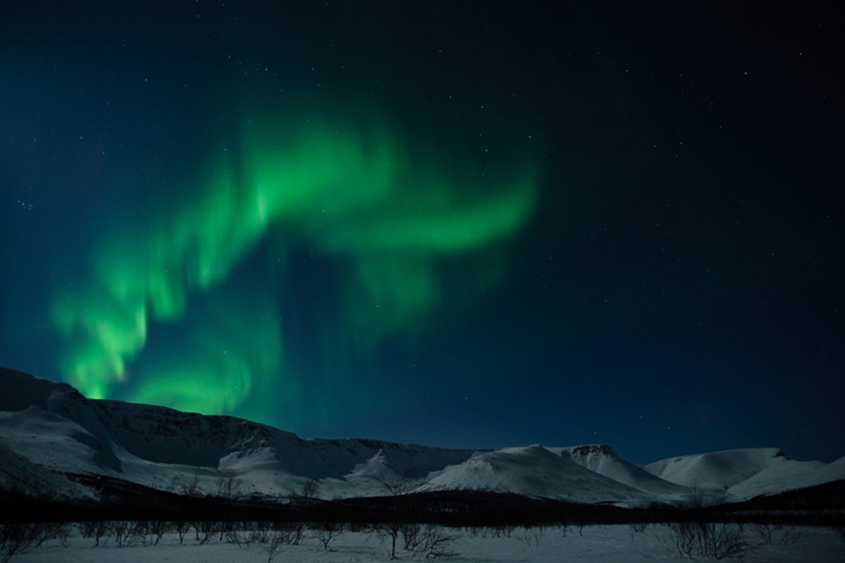The northern lights above the mountains.    