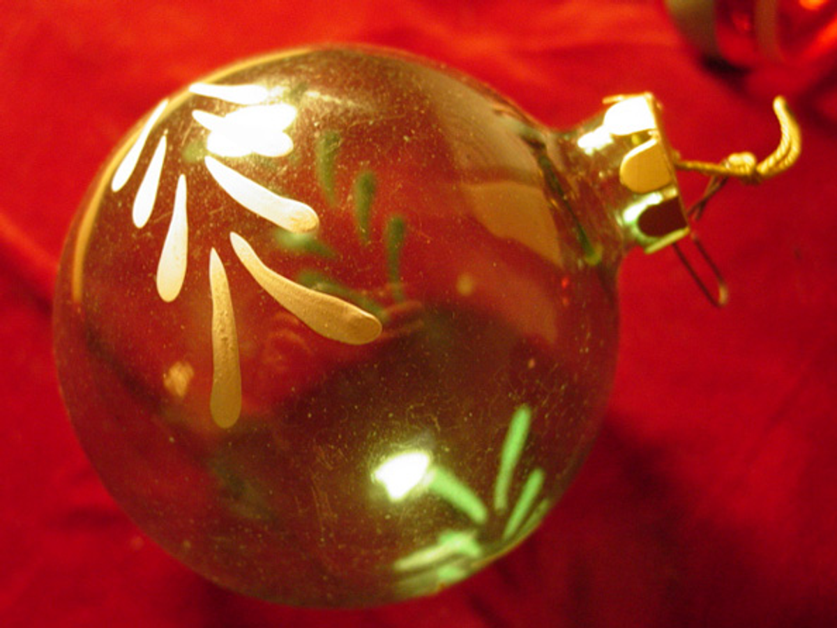 Hand-painted glass ornament produced in the 1940s during WWII. The cardboard cap replaced the traditional metal cap and hook due to material shortages during the war.   (Helen West)