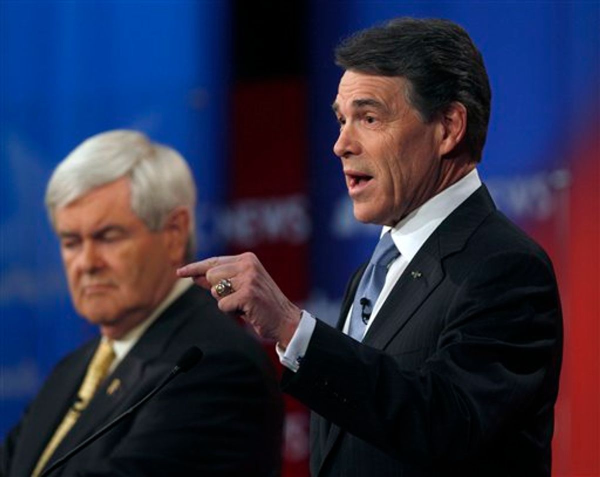 Texas Gov. Rick Perry answers a question as former House Speaker Newt Gingrich listens in the background during a Republican presidential candidate debate at the Capitol Center for the Arts in Concord, N.H., Sunday, Jan. 8, 2012. (AP Photo/Charles Krupa)                           (AP)