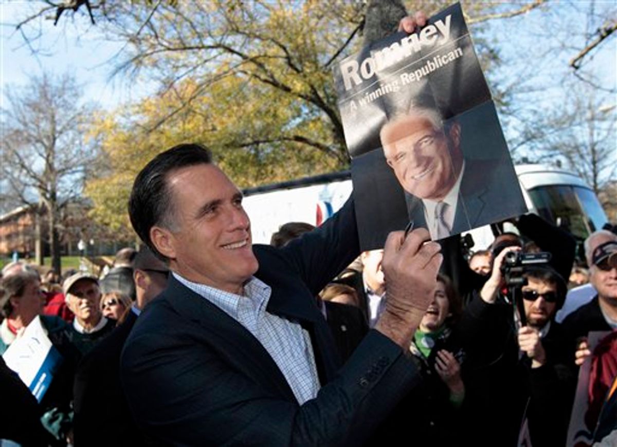 Mitt Romney holds up a poster of his father George Romney, Spartanburg, S.C., Jan. 18, 2012. (AP Photo/Charles Dharapak)     (AP)