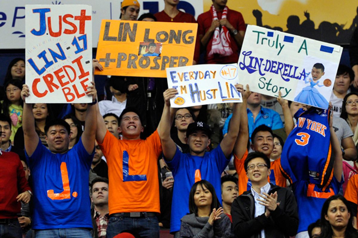 Fans of Jeremy Lin hold up signs during the second half of the New York Knicks/Toronto Raptors game on Tuesday.   (Reuters/Mike Cassese)