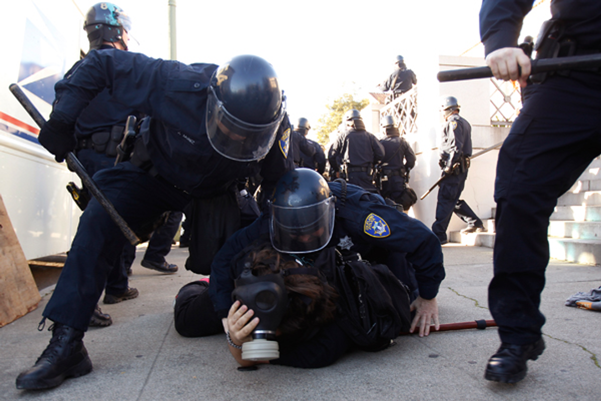 Members of the Oakland Police Department arrest an Occupy Oakland demonstrator in Downtown Oakland, California January 28, 2012        (Reuters/Stephen Lam)