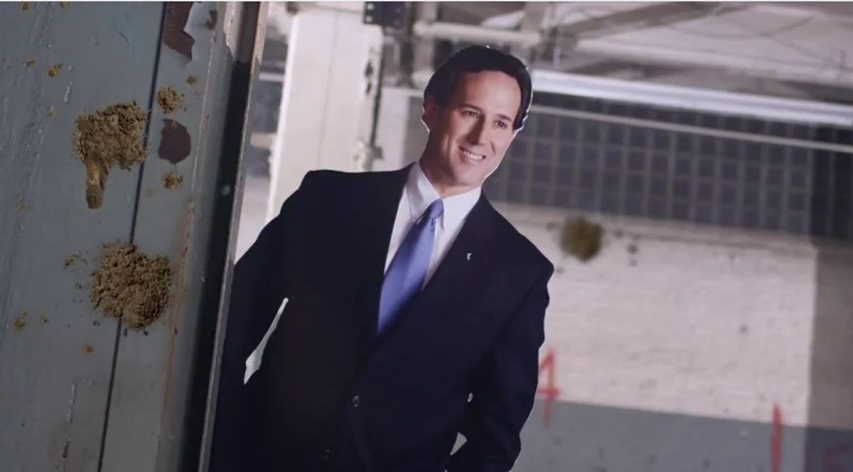 A Rick Santorum cut-out, with "mud"       (Rick Santorum/YouTube)