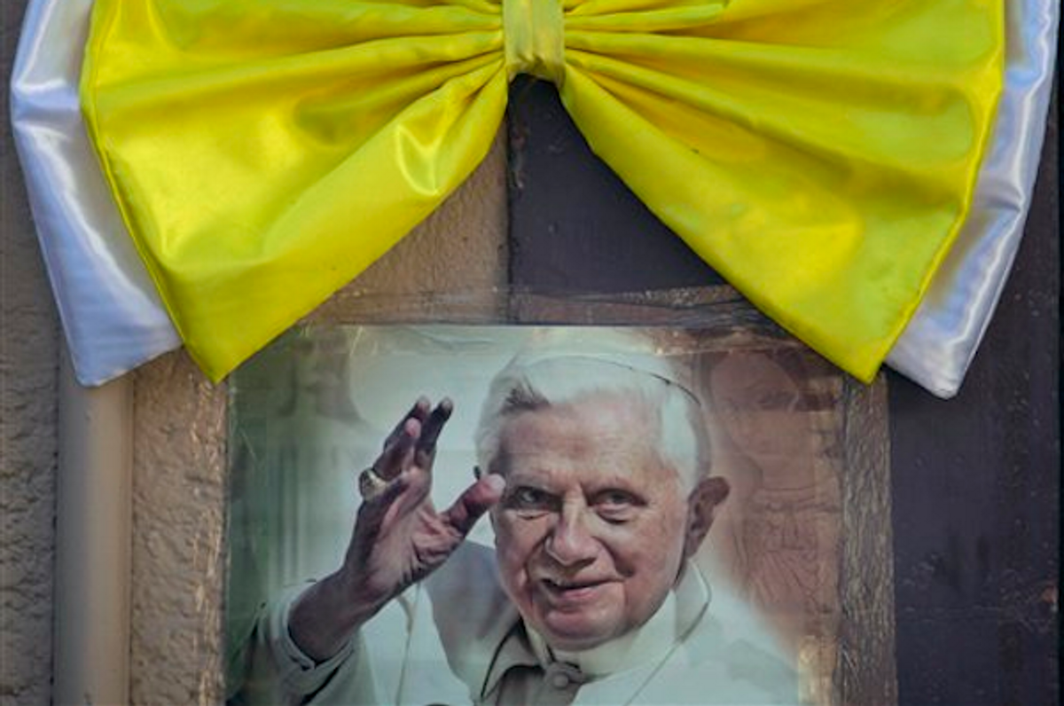 An image of Pope Benedict XVI is taped to a wall, topped with a Vatican-colored bow, in Leon, Mexico, Thursday March 22, 2012                  (AP Photo/Eduardo Verdugo)