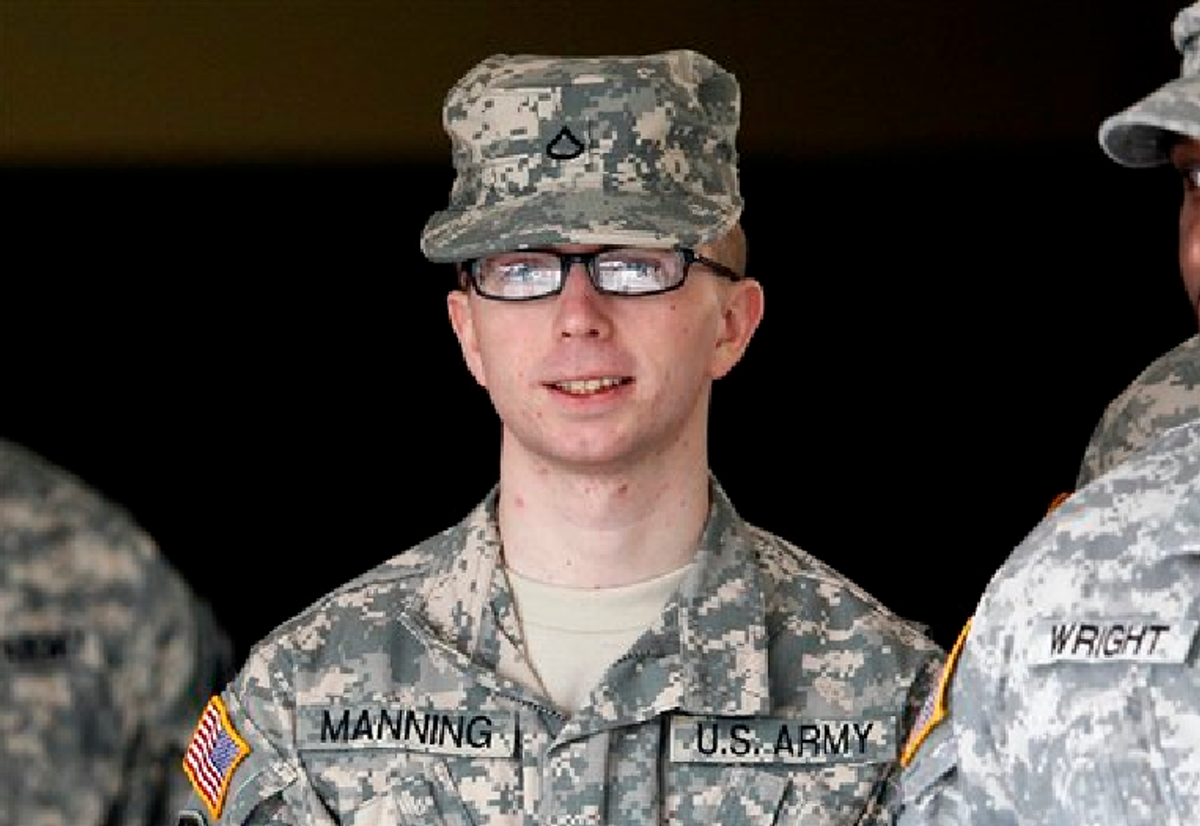 FILE - In this file photo taken Dec. 22, 2011, Army Pfc. Bradley Manning is escorted from a courthouse in Fort Meade, Md.  (AP Photo/Patrick Semansky, File)