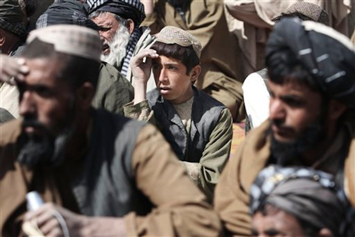 Afghan villagers during prayer ceremony for victims of Sunday's killing of civilians by a U.S. soldier in Panjwai, Kandahar province, Afghanistan, Tuesday, March. 13, 2012     (AP Photo/Allauddin Khan)
