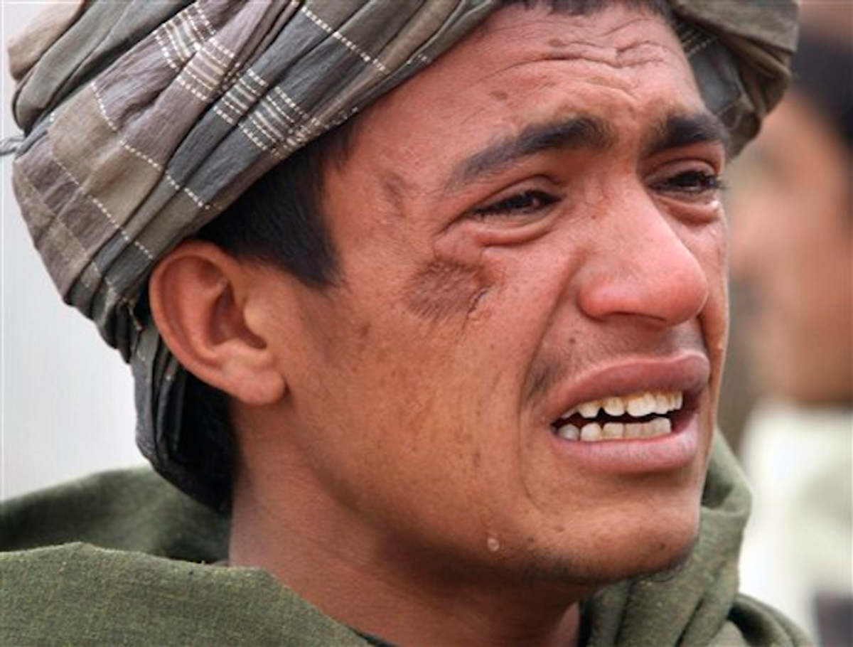  An Afghan youth mourns for relatives, who were allegedly killed by a U.S. service member in Panjwai, Kandahar province in Afghanistan, Sunday, March. 11, 2012           (AP Photo/Allauddin Khan)