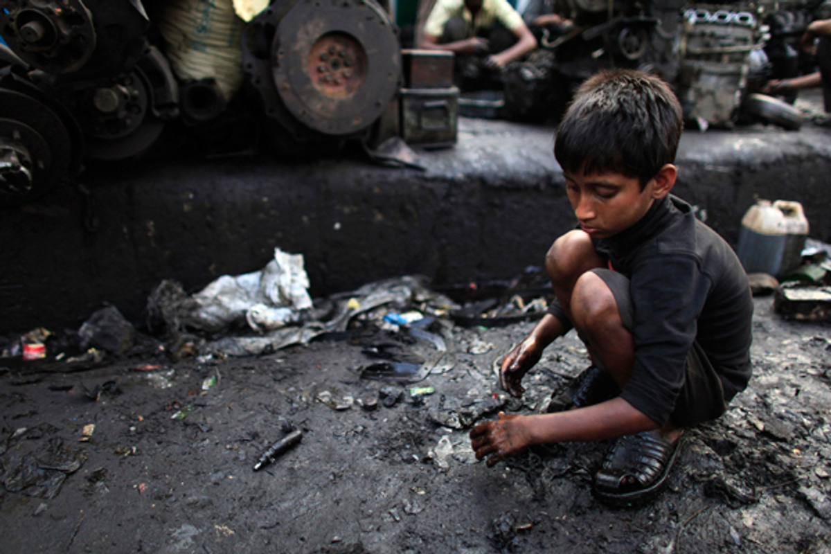 A boy collects scraps near a vehicle spare parts store in Dholaikhal, Dhaka February 29, 2012             (Reuters/Andrew Biraj)