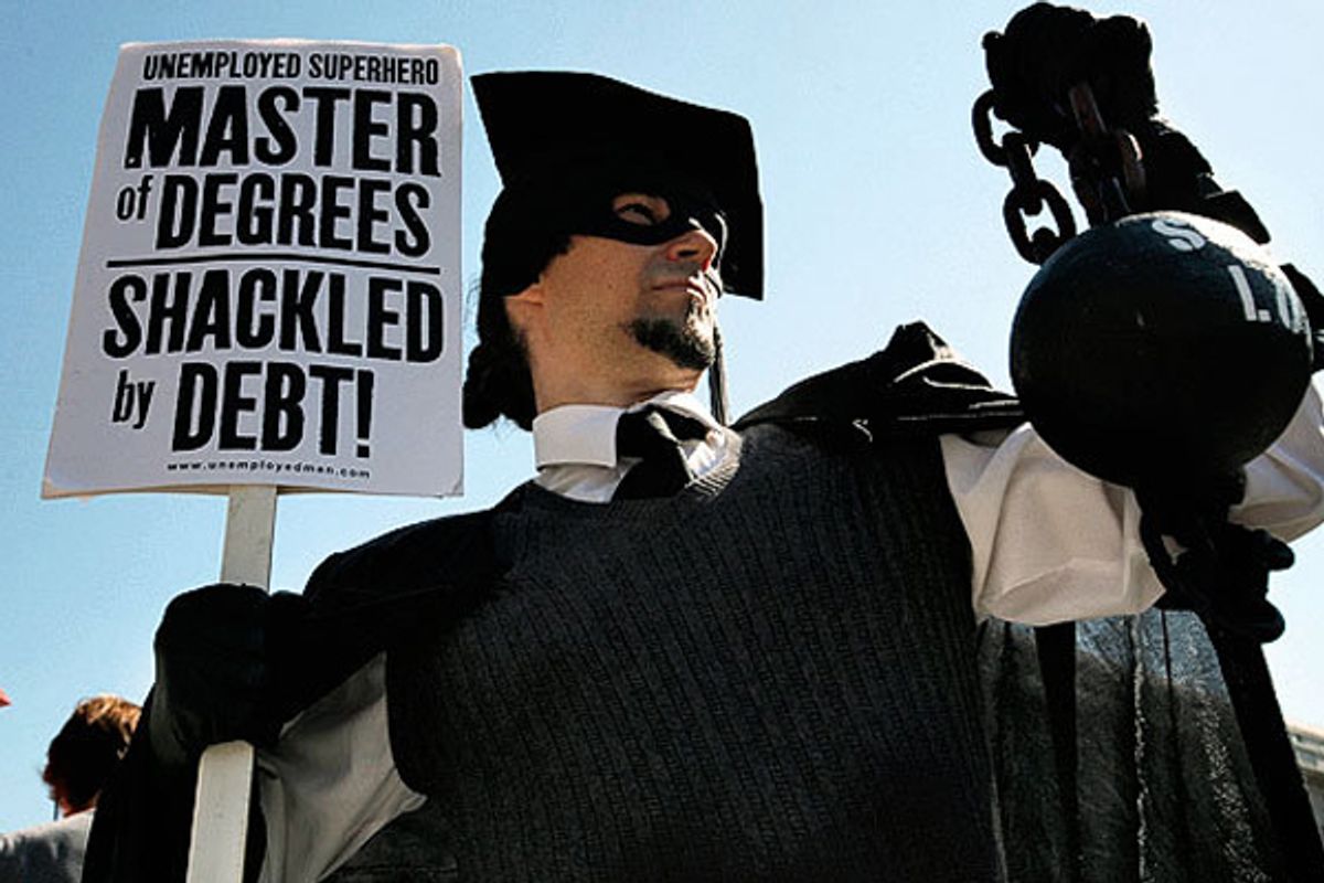 A protester holds a ball and chain representing his college loan debt during an Occupy DC protest in Washington.        (AP/Jacquelyn Martin)
