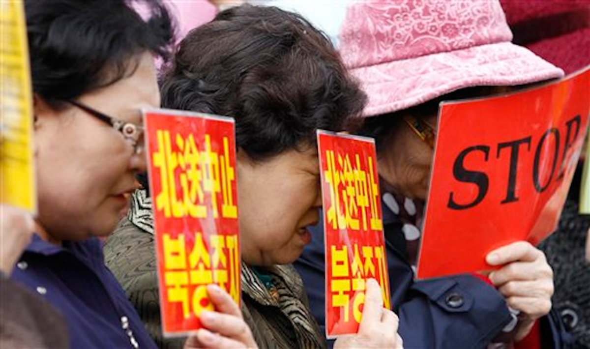  North Korean defectors react during a rally against Chinese government near the Chinese Embassy in Seoul, South Korea, Wednesday, March 7, 2012      (AP Photo/Lee Jin-man)