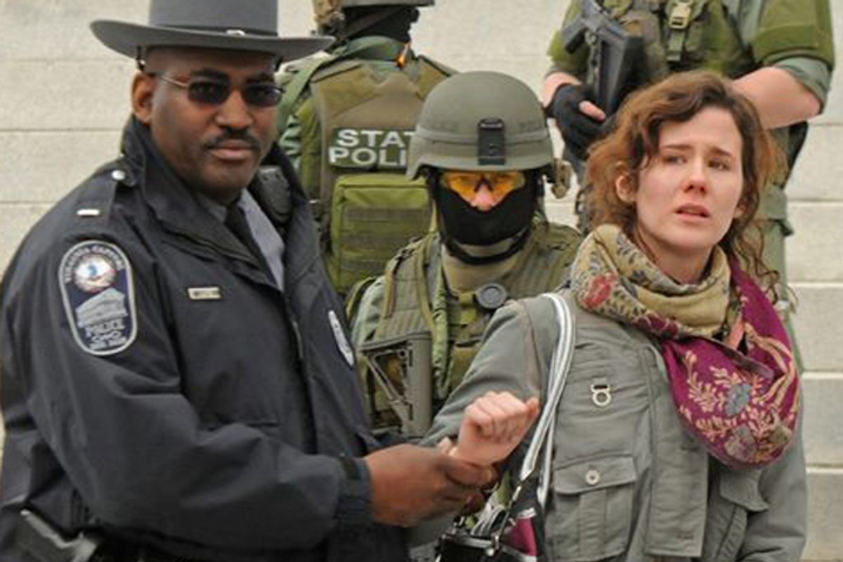 A woman protesting Virginia's mandatory ultrasound law is arrested on the capitol steps in Richmond on March 3.     (<a href='https://www.facebook.com/media/set/?set=a.10150720349477642.471133.48762312641&type=3'>Style Weekly</a>)