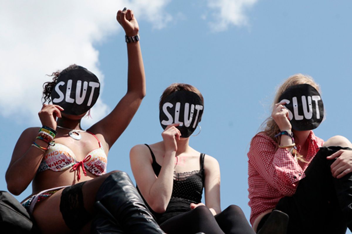 SlutWalk participants cheer a speaker        (Olivia Harris / Reuters)