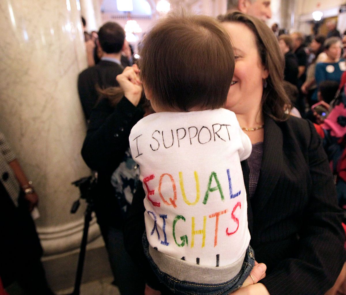 Rep. Anne Kaiser, D-Montgomery, an openly gay member of the Maryland General Assembly, holds Natalie Vincent, 10 months, the daughter of a member of Maryland Gov. Martin O'Malley's staff, after O'Malley signed the Civil Marriage Protection Act on Thursday.