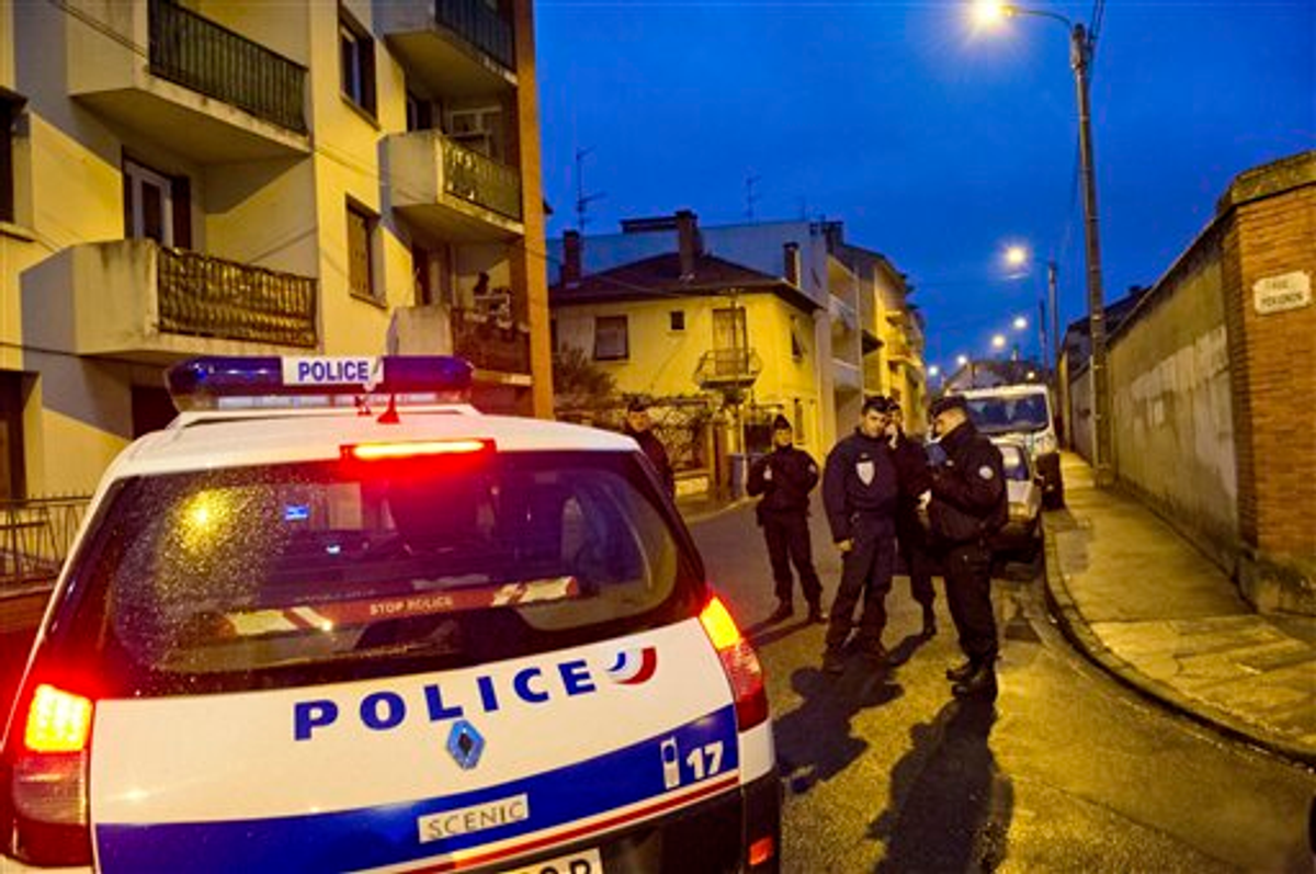  French police secure the area where they exchanged fire with a gunman who claims connections to al-Qaida and is suspected of killing three Jewish schoolchildren, a rabbi and three paratroopers, Wednesday, March 21, 2012 in Toulouse, southwestern France          (AP Photo/Bruno Martin)