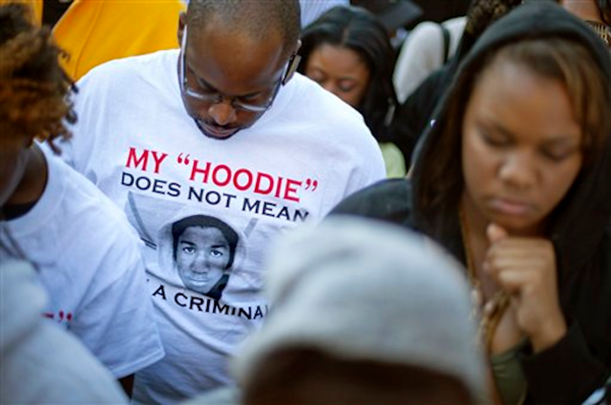 A demonstrator wears a t-shirt in memory of Trayvon Martin during a rally outside the Georgia Capitol, in Atlanta on Monday, March 26, 2012             (AP Photo/David Goldman)