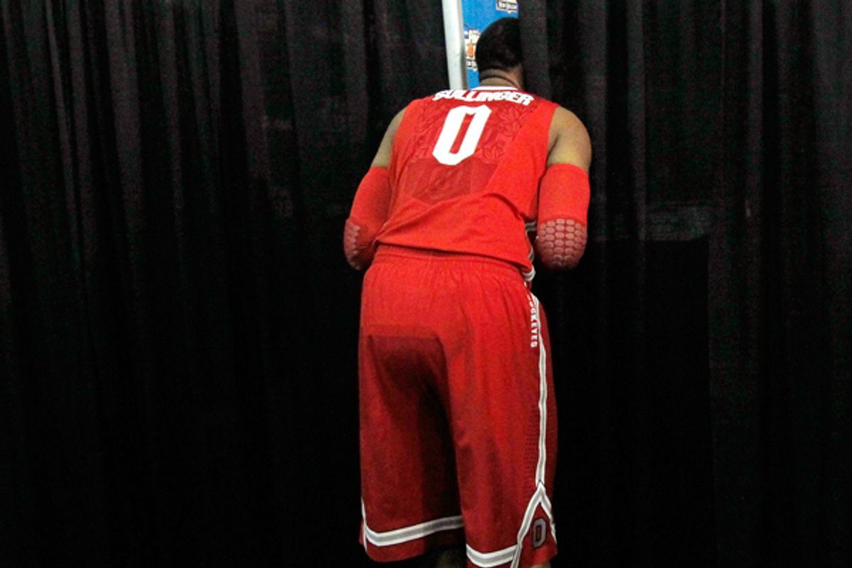Ohio State forward Jared Sullinger peeks through a curtain while teammates participate in interviews in New Orleans on March 29.      (AP/Gerald Herbert)