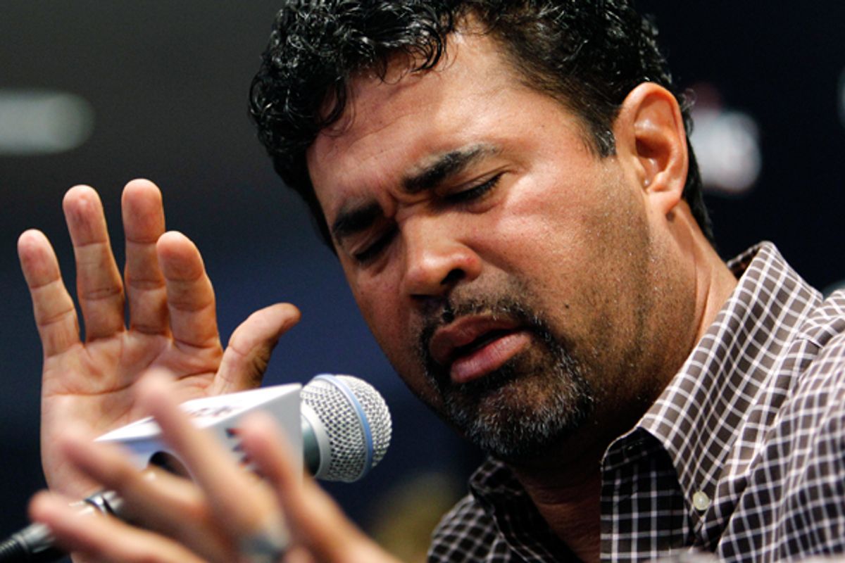 A contrite Miami Marlins manager Ozzie Guillen gestures at a news conference on Tuesday.  (AP/Lynne Sladky)