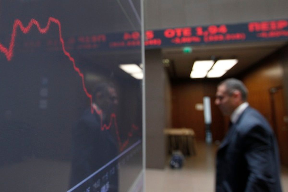 A man is reflected in the chart with stock prices at the Greek Stock Exchange in Athens, Monday, May 14, 2012. (AP Photo/Petros Giannakouris)        (AP)