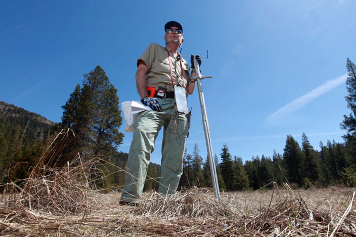 Frank Gehrke, chief of snow surveys for the Department of Water Resources, stands in a snow-free meadow at Echo Summit, Calif. Warm spring weather, combined with lower then normal precipitation, caused the statewide snowpack water content to be only 40 percent of normal for this time of year.        (AP/Rich Pedroncelli)