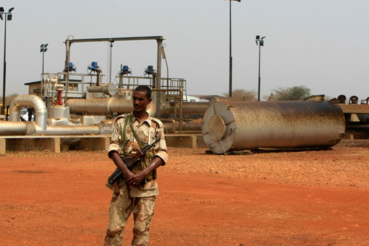 A member of the military stands guard near pump stations before a
ceremony in which oil operations at Heglig oilfield will resume in
Heglig, Sudan, May 2, 2012.
       (Reuters/Mohamed Nureldin Abdallah)