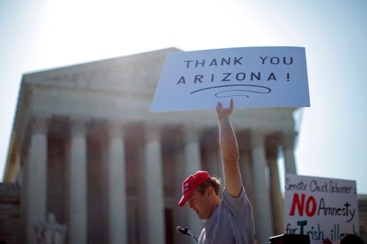 A supporter of Arizona's "show me your papers" immigration law demonstrates in front of the Supreme Court.                 (AP/Charles Dharapak)