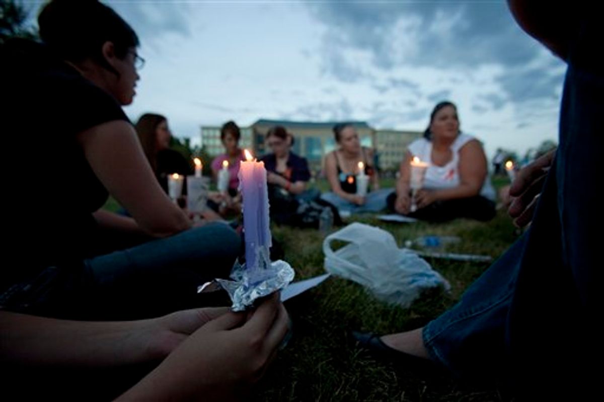A group of friends with various connections to the deceased and wounded gather at a prayer vigil  outside the Aurora Municipal Center in Aurora, Colo.,(AP/Barry Gutierrez)    (Associated Press)