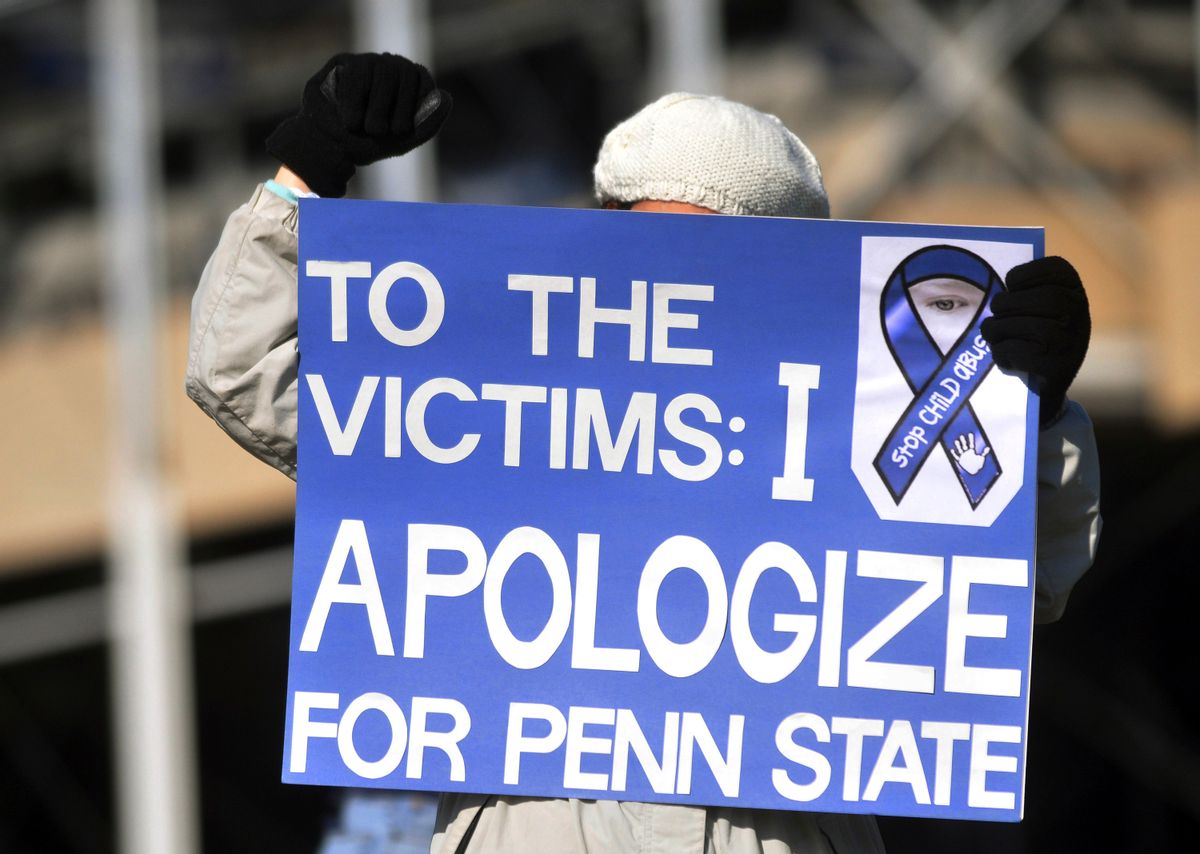 An unidentified protestor stands outside Beaver Stadium prior to the  football game between Nebraska and Penn State last November.   (Reuters/Pat Little)