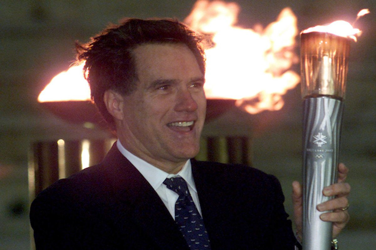 President of the organizing committee for the Salt Lake City Winter Olympic Games, Mitt Romney smiles as he raises an Olympic torch on December 3, 2001, during a handing-over ceremony in Athens' Panathenean stadium.      (REUTERS/Yorgos Karahalis)