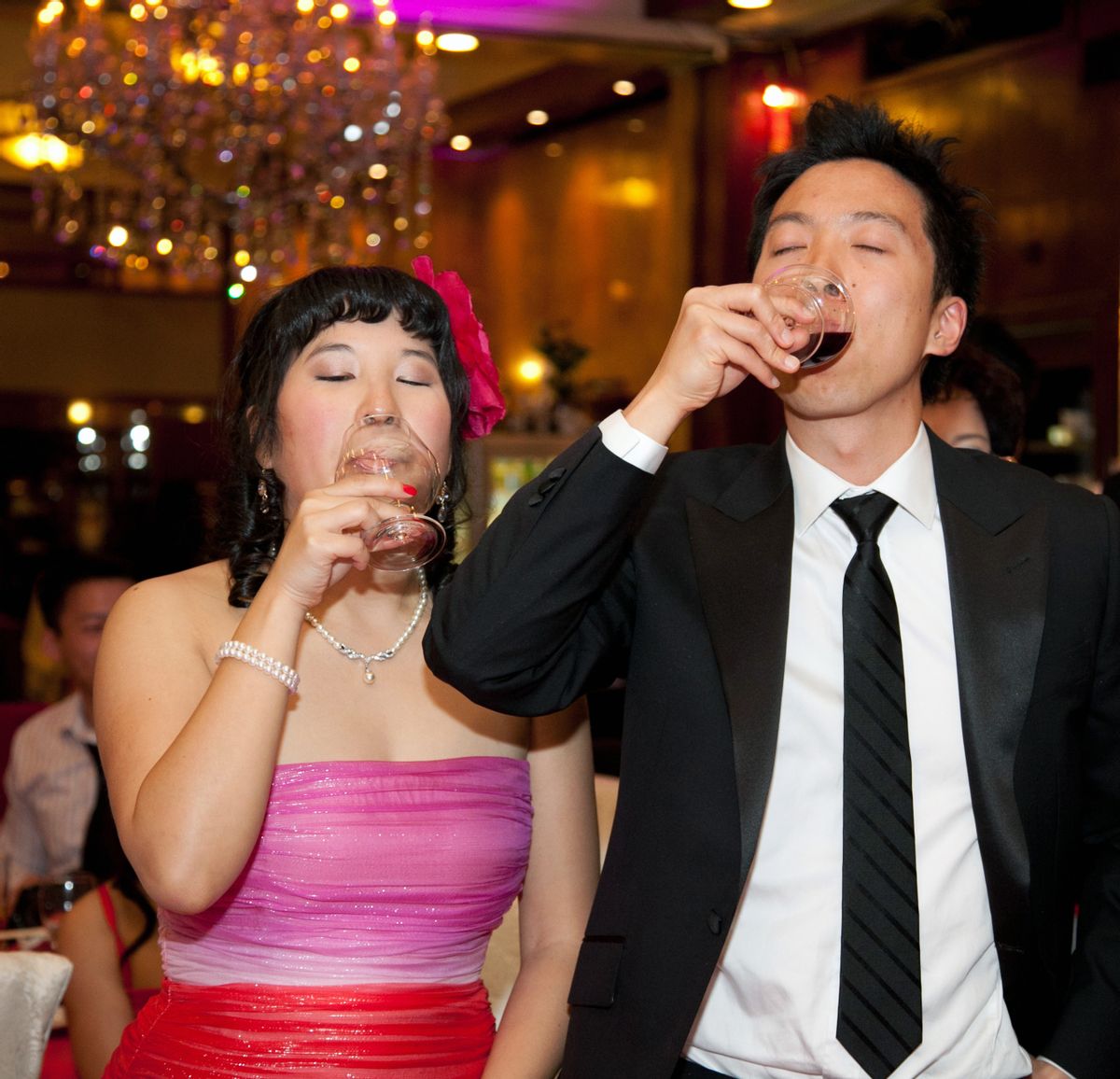 A photo of the author and her husband taking one of many cognac shots on her wedding night.  