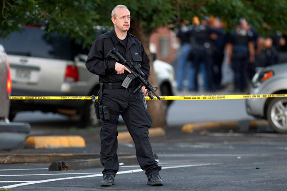 A SWAT team officer stands watch near an apartment house where the suspect in a shooting at a movie theater lived in Aurora, Colo., July 20, 2012.    (AP/Ed Andrieski)