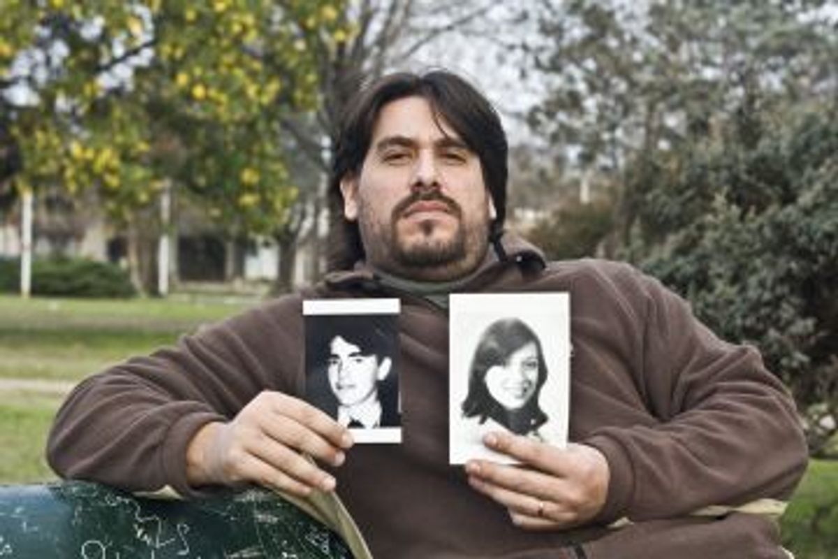 Guillermo Perez Roisinblit holds pictures of his biological parents. He's one of hundreds of victims of the Argentine military regime's baby abduction scheme.  (Ed Stocker, GlobalPost)