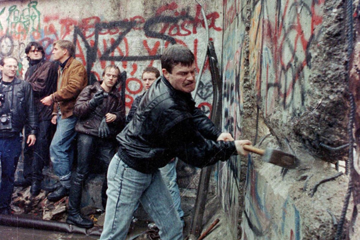 A demonstrator attacks the Berlin Wall with a sledgehammer in November 1989.    (Reuters)