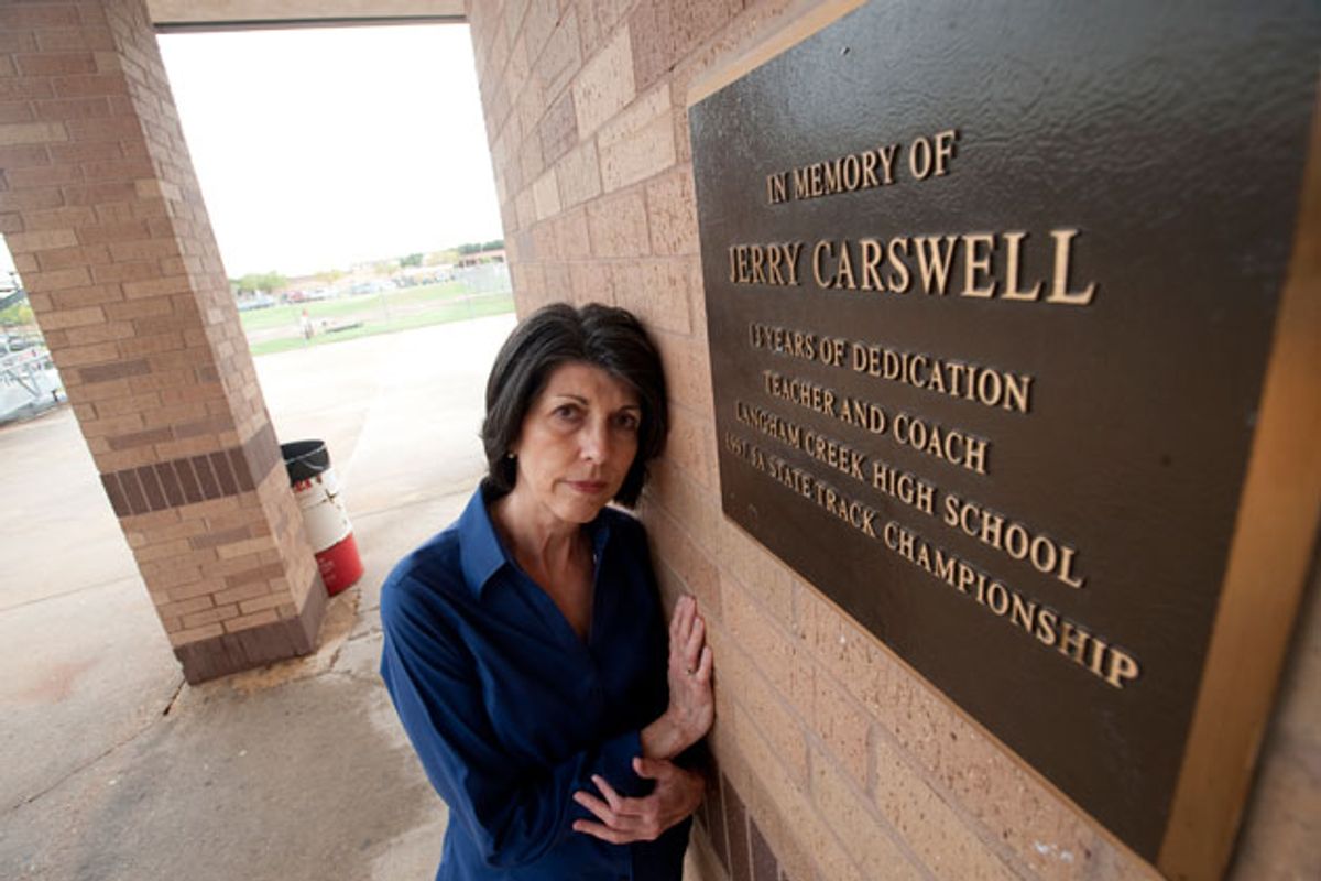 Linda Carswell poses at the Langham High School track by a memorial plaque for her husband. Her lobbying and testimony played a crucial role in the Jerry Carswell Memorial Act, a new informed consent for autopsies bill passed in Texas this year. (Sharon Steinmann/ProPublica)