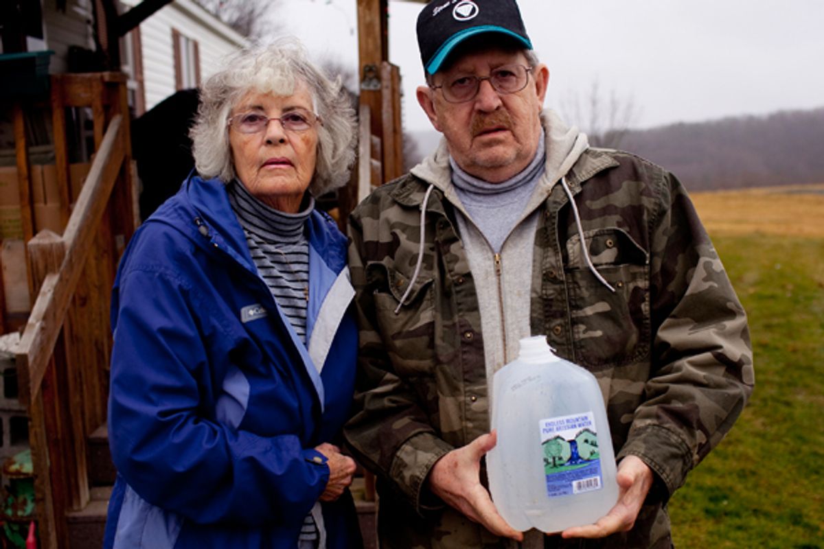 Ron and Jean Carter hold a bottle of well water outside their home in Dimock, Pennsylvania. The Carters are suing Cabot Energy for allegedly poisoning their well with toxic chemicals and water. (Reuters/Les Stone)                      