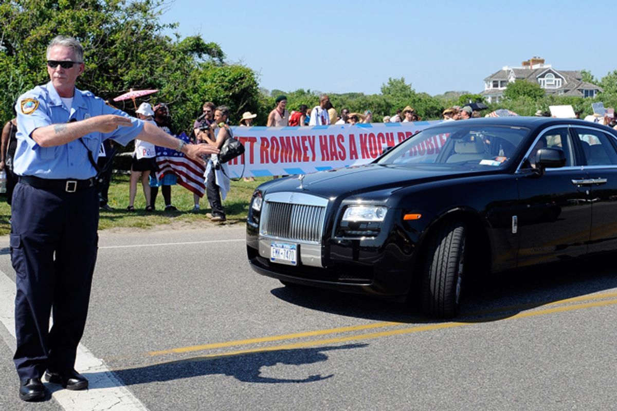 A Southampton police officer directs a Rolls Royce around protestors outside the estate of David Koch before a fundraiser for Mitt Romney on Sunday.  (AP/Kathy Kmonicek)