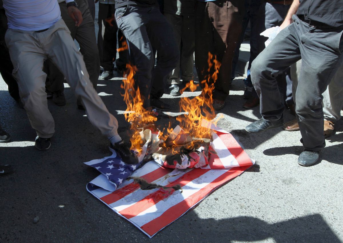 A mock U. S. flag set on fire by a group of about 50 angry Islamists near the U.S. embassy in Ankara, Turkey.         (AP/Burhan Ozbilici)