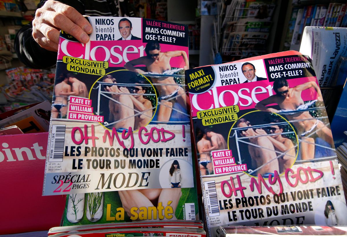A man holds a copy of the French magazine Closer showing pictures of Catherine, Duchess of Cambridge, and Britain's Prince William are displayed in a newspaper kiosk in Nice.    (Eric Gaillard/Reuters)