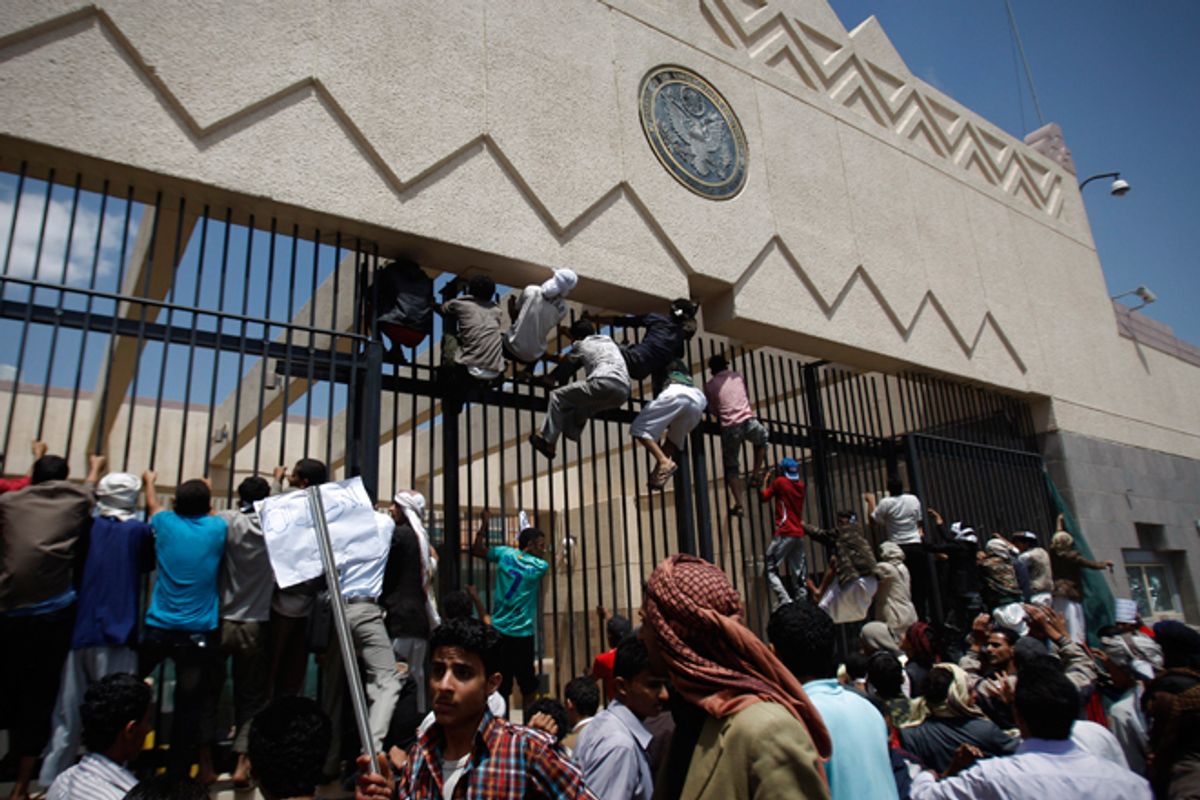 Yemeni protestors climb the gate of the U.S. Embassy during a protest about a film ridiculing Islam's Prophet Muhammad, in Sanaa, Yemen, Thursday, Sept. 13, 2012.        (AP/Hani Mohammed)