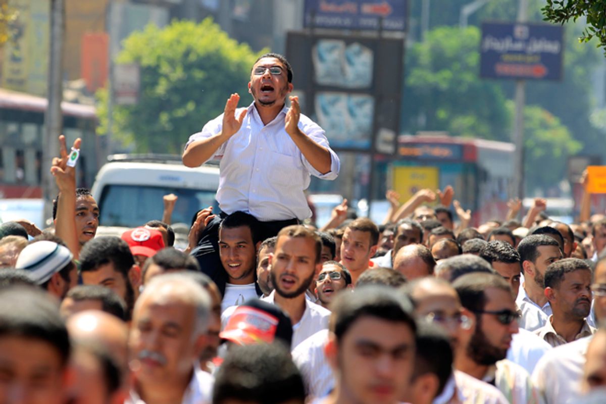 A man cheers during a Muslim Brotherhood protest in Cairo in support of the uprising in Syria.      (Reuters/Mohamed Abd El Ghany)
