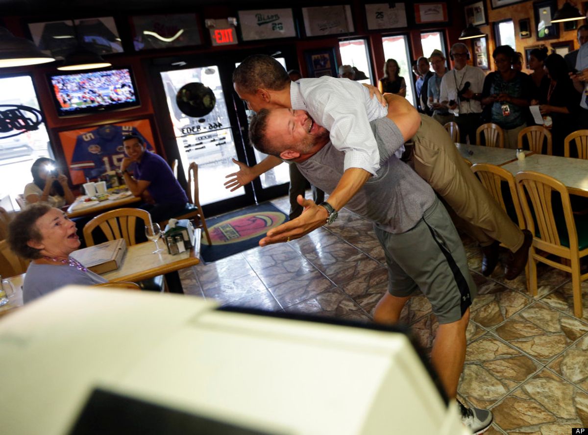 President Barack Obama, right, is picked-up and lifted off the ground by Scott Van Duzer, left, owner of Big Apple Pizza and Pasta Italian Restaurant during an unannounced stop, Sunday, Sept. 9, 2012, in Ft. Pierce, Fla. (AP Photo/Pablo Martinez Monsivais)           (Associated Press)
